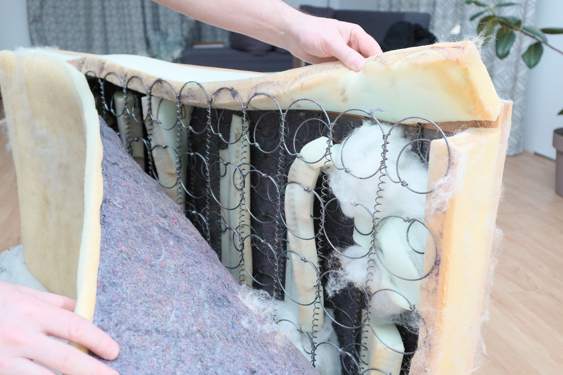 Mattress sofa sectioned inside. Man repairing a sofa. Furniture repair shot. Selective focus